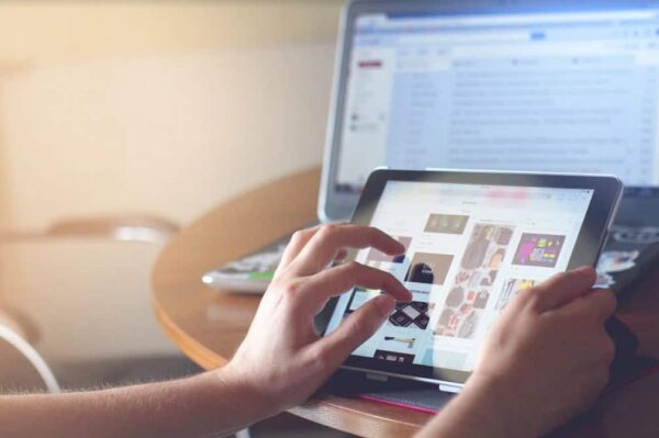 A Person Browsing A Website Using A Tablet