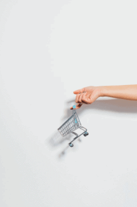 Hand Holding A Mini Push Cart Toy