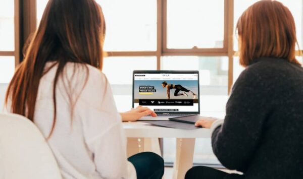 Two Women on A Laptop Looking At A Website