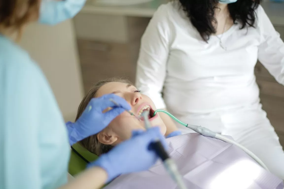 A Woman Undertaking A Dental Procedure