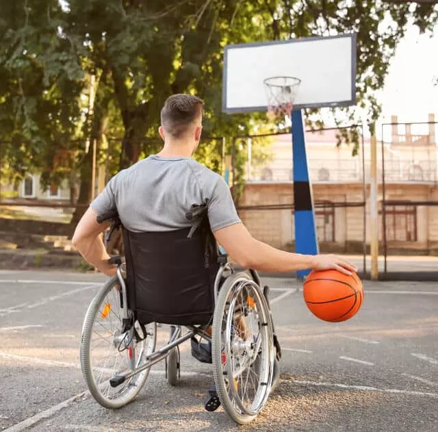 Man on A Wheelchair Playing Basketball