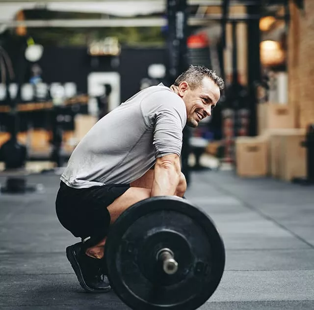 Smiling Man With A Huge Barbell