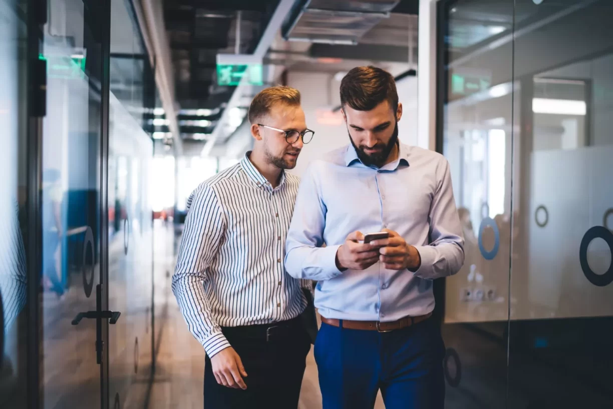 Two Young Men Looking At A Smart Phone