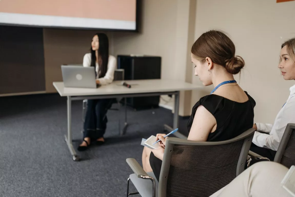 Woman Taking Notes in The Meeting