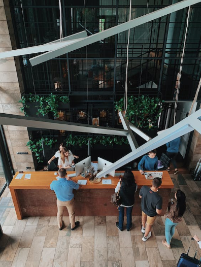 A high angle view of people at a hotel reception desk