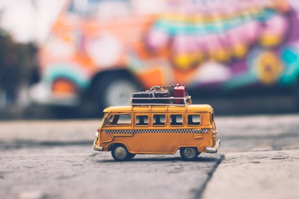Selective Focus Photography of Yellow School Bus Carrying Luggages