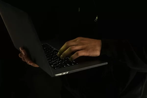 Man Typing on A Laptop